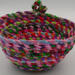 This shows the "backside" of the basket with the back of the knot. The base of the bowl is about 5" and the width is about 7.5" by 4" deep. This shows the "backside" of the basket with the back of the knot. The base of the bowl is about 5" and the width is about 7.5" by 4" deep.